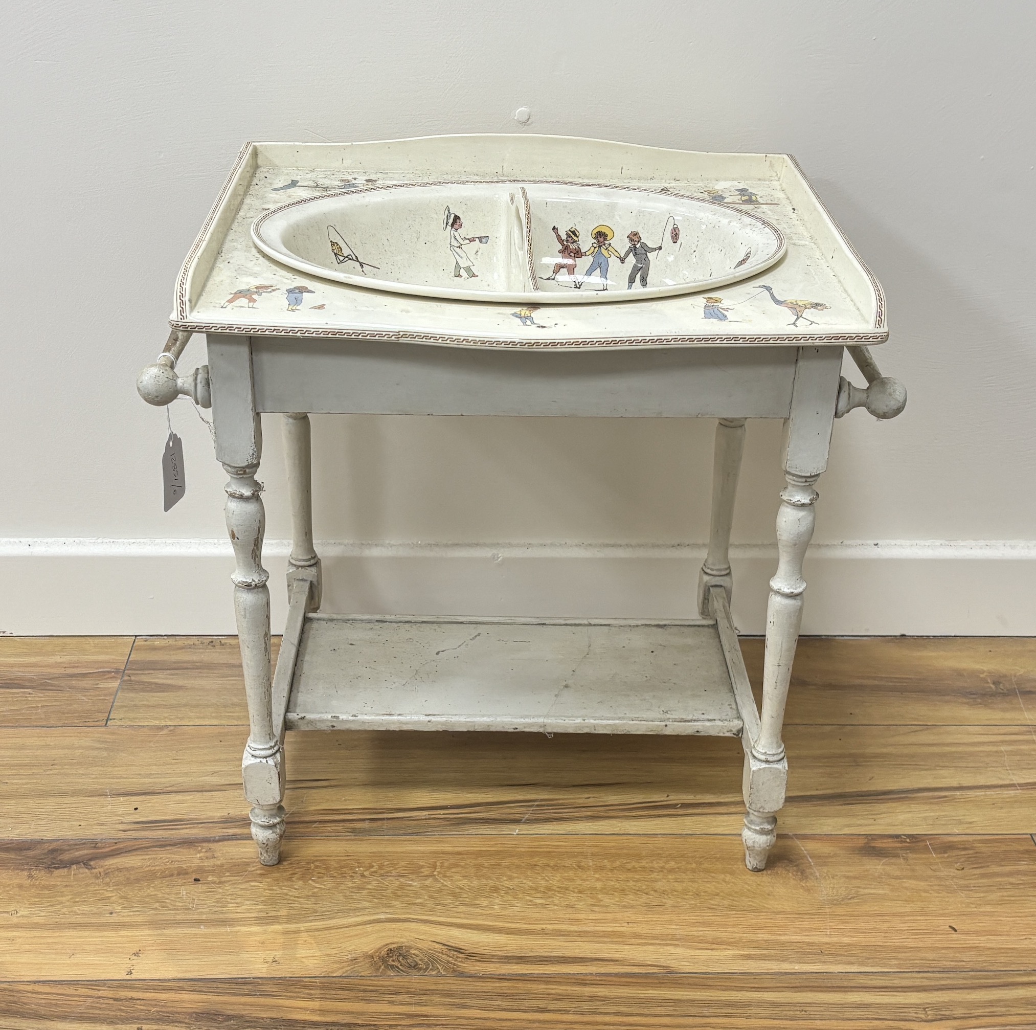 A French Sarreguemines pottery child's basin decorated with nursery scenes and matching wash stand, 51 x 37 x 48cm